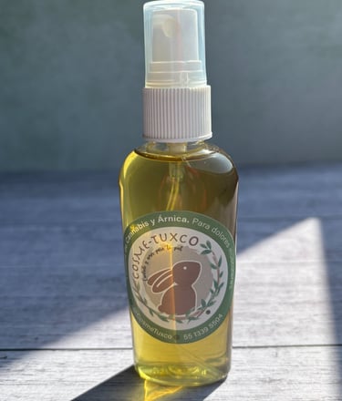 Natural cannabis and arnica massage oil spray for muscle pain relief in a glass bottle.