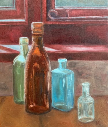 An original oil painting of four coloured glass bottles on a window ledge