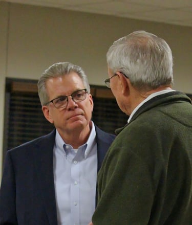 Dale Usher talking with a resident of Graves County