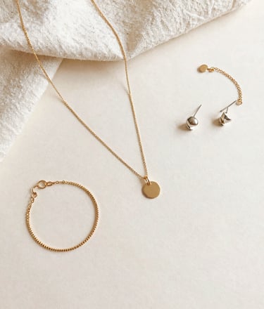 A stylish bracelet featuring semi-precious stones on a rustic wooden table.