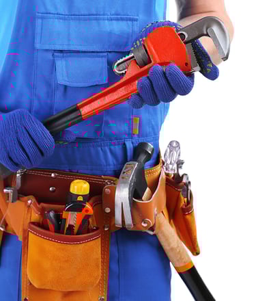 Professional technician holding plumbing tools for HVAC and plumbing maintenance services