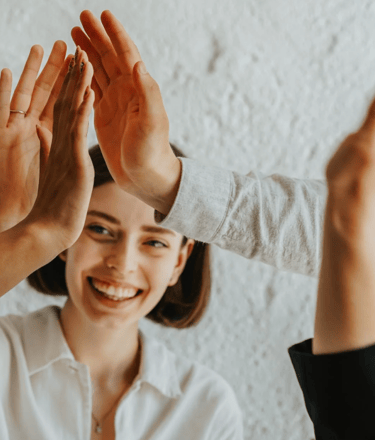 a woman is giving a high five finger sign