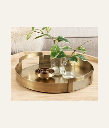 Picture of Transitional Metal Round Tray in gold on a light wood table