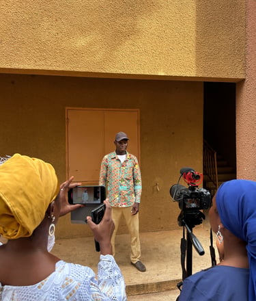 Kofi Dotse behind youth storytellers undertaking a field exercise