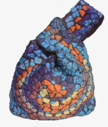 Handmade felted wool mosaic knot bag featuring a colorful stained glass pattern in blue, orange, and purple.