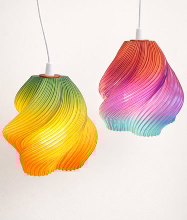 Set of custom 3D printed spiral lamps in multiple colors on neutral background