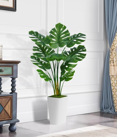 Artificial Monstera Deliciosa plant in a white pot for modern home decor.