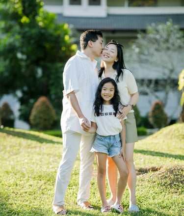 Family portrait in the tropical gardens of InterContinental Bali Resort during golden hour