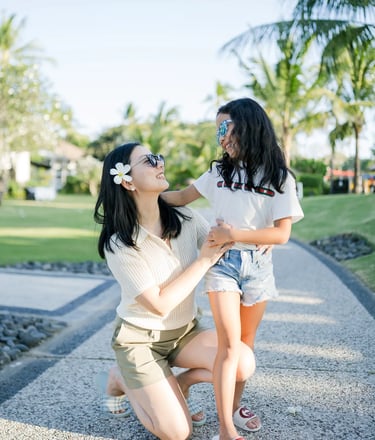 Mother and daughter sharing a joyful moment during a family photography session at InterContinental Bali Resort