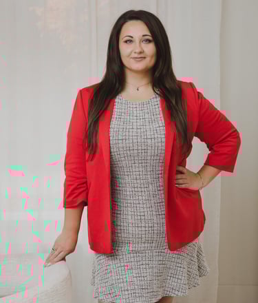 Adriana portrait of a brunette businesswoman in a red blazer and tweed dress.