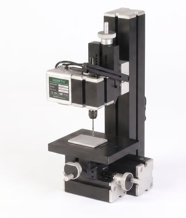 Operating a hand press drill to create clearance holes for robotics.