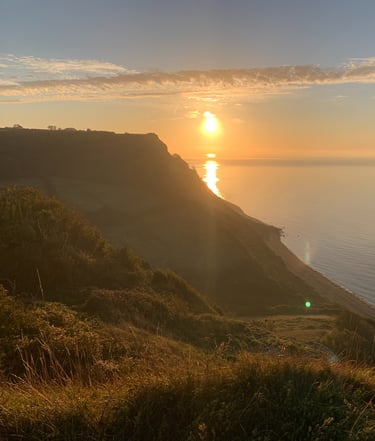 A view of the sunset overlooking the ocean and coast