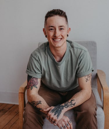 a person sitting in a chair and smiling