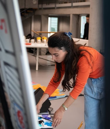 Sofia is painting a canvas for a live art performance. Photo by Emmanuelle Dekkers