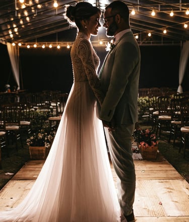 a bride and groom standing in a tent