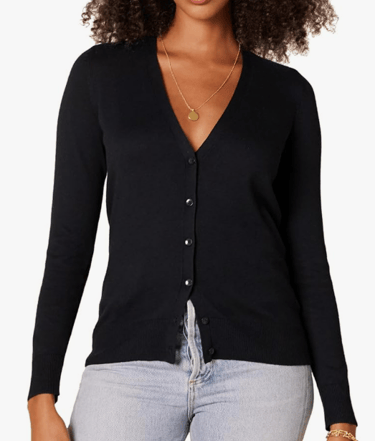 a woman wearing a black cardigan and light denim jean pants