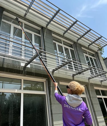 Dronicle spraying filtered water on windows