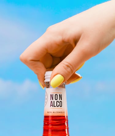 a person holding a bottle of alcohol in a bottle