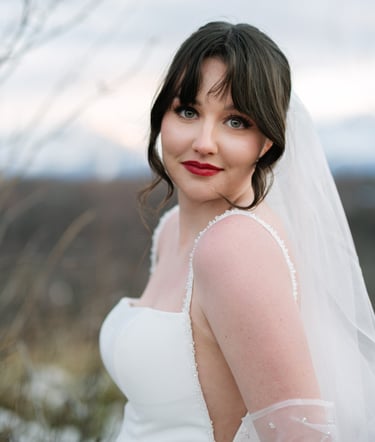 a bride in a white wedding dress and veil