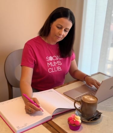 Content creator planning digital content and workshop notes while working at a laptop