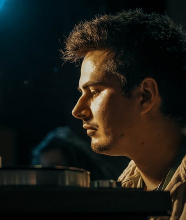 a man sitting at a table with a laptop