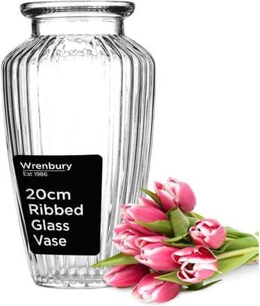 a vase with a vase of flowers and a bottle of wine