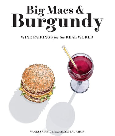 a glass of wine and a sandwich on a table