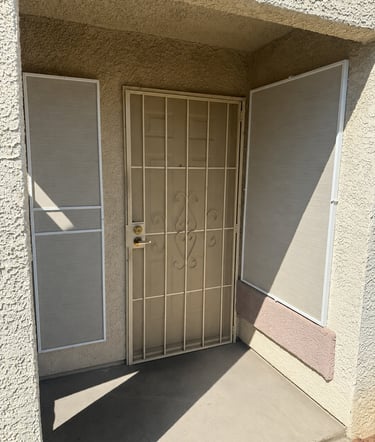 Front door of condo with new solar screens and frames.
