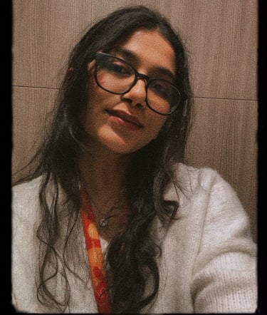 a woman with glasses and a tie around her neck