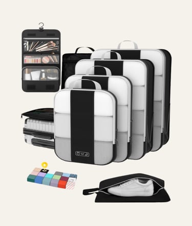 Set of black and white packing cubes, hanging toiletry bag, and shoe bag for organized travel luggage.