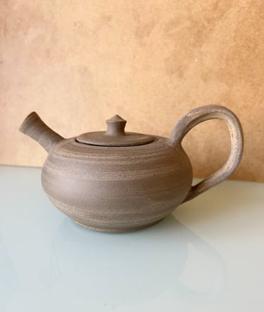 a teapot with a teapot on a table