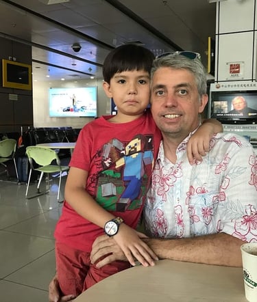 a man and a boy sitting at a table there faces sad as they are seperated for 8 years