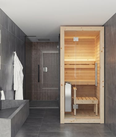 Modern home spa bathroom featuring a compact indoor cedar sauna next to a walk-in glass shower.