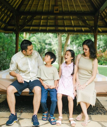 family relaxing together during photography session at Westin Nusa Dua Bali resort lounge area