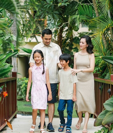 family walking together during photography session at Westin Nusa Dua Bali tropical garden path