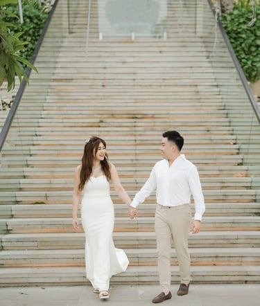 Couple walking down the iconic grand staircase during a prewedding photoshoot at Apurva Kempinski Bali