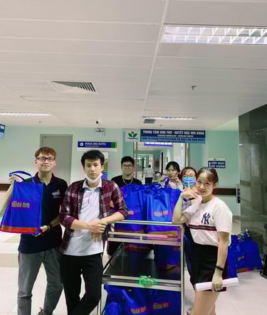 a group of people standing around a carton