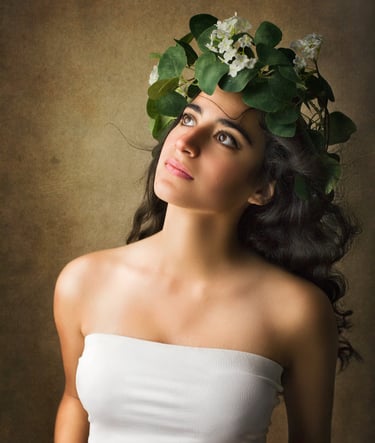 a gorgeous girl with long black curly hair looking up as the wind blows her hair away, she wears a vines crown with flowers