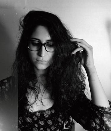 a woman with glasses and a flowered dress