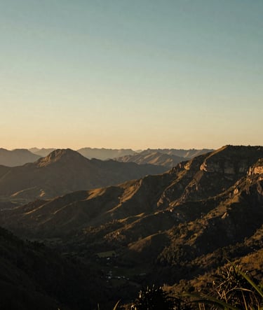 Wide cinematic shot of a sunset over the mountains of the Vale do Aço in South America / Brazil, with Ocean Slate and Soft Sage tones in the sky, captured with a professional film aesthetic.