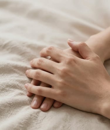 Close-up macro shot of two hands gently intertwined, resting on a soft #C8B6A6 beige textured fabric. Elegant morning light creates soft shadows. The image captures the authentic intimacy of the brand, utilizing a palette of #7B6654 and #F8F5EF.