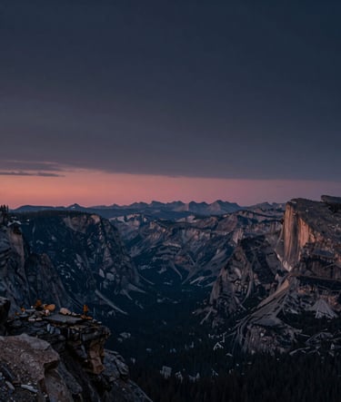 A breathtaking landscape photograph of a North American / US national park at sunset. Deep dark navy and blue-grey sky with a sliver of muted rose on the horizon. High detail, wide angle, professional photography.