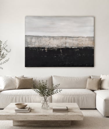 Modern living room with a white sectional sofa, stone coffee table, and large abstract landscape wall art.