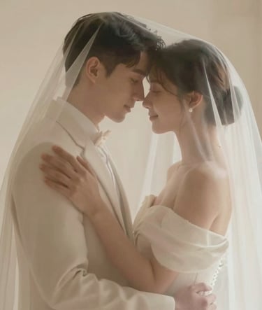 A timeless wedding portrait of a couple embracing under a sheer veil, soft focus, warm and sophisticated lighting, highlighting the #F5F2F0 cream tones.