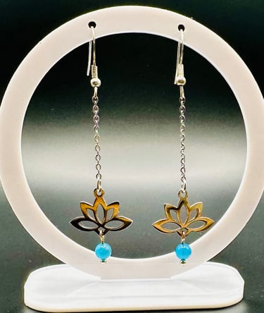 a pair of earrings with a gold and blue flower