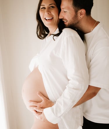 matenrigy couple photo holding baby bump, taken in studio Littlehampton