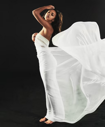 Femme sensuelle enroulée dans un drap blanc