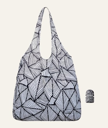 Foldable Nanobag reusable grocery tote with a black and white geometric leaf pattern and its compact carry pouch.