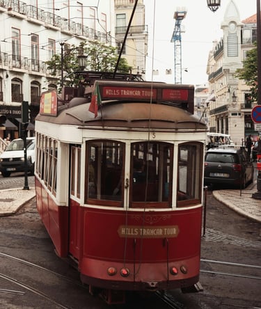 Historic tram moving through narrow streets in Lisbon, Portugal