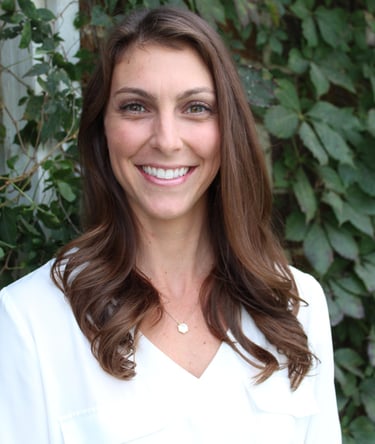 a smiling woman in a white shirt
